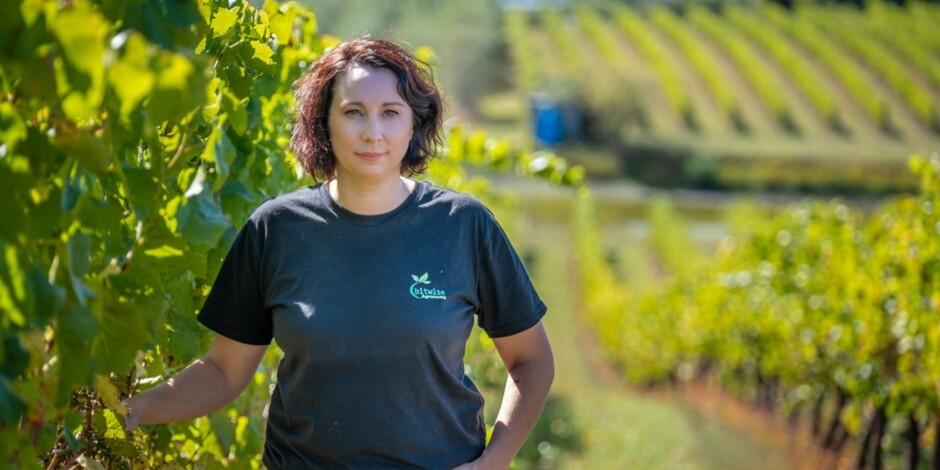 woman standing in vineyard grapes