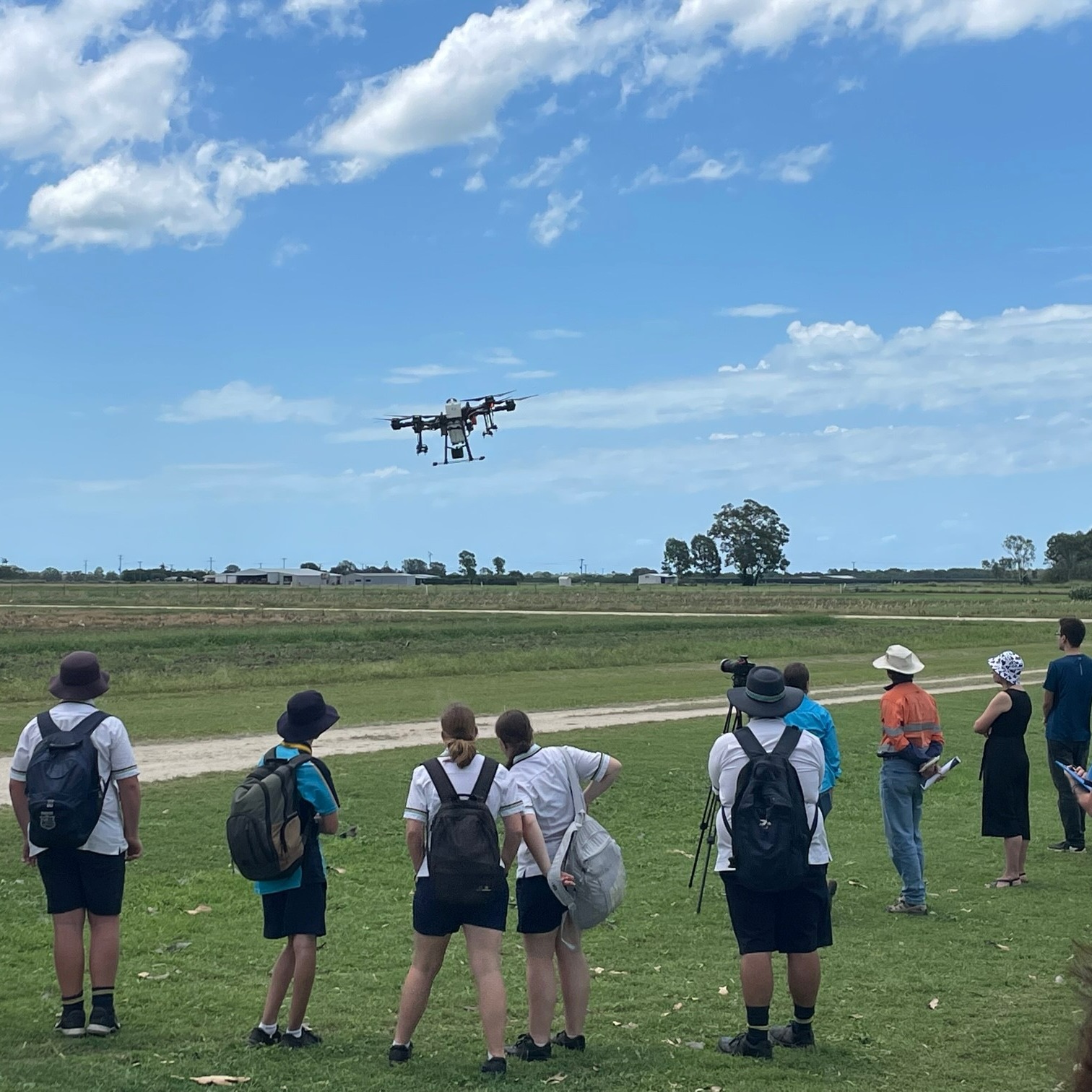 Students watch a drone